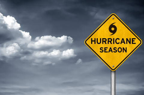 Hurricane season sign with storm clouds in the background.