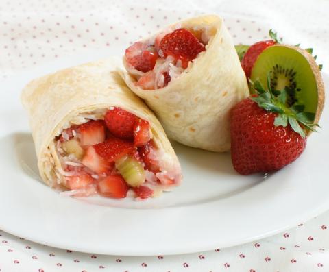 Fruit dessert burrito stuffed with strawberries